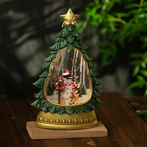 Christmas tree snow globe with snowman and reindeer on embossed gold base with LED light