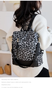 Rear view of model wearing a stylish leopard print backpack with adjustable straps