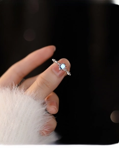 Detail of S925 silver moonstone ring with sparkling zircons on a soft velvet sleeve