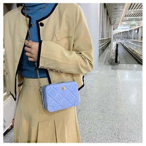 Blue quilted PVC jelly bag with gold chain strap and lion head buckle detail