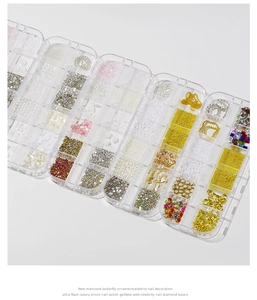 Detailed assortment of nail art gems, pearls, and crystals in a transparent organizer box