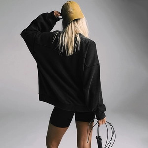 Back view of a casual loose black sweatshirt with long sleeves for autumn sportswear