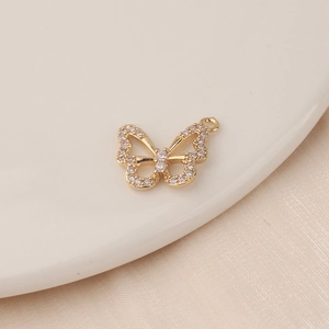 Macro shot of a gold-plated butterfly pendant featuring sparkling zircon stone inlay