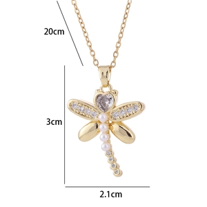 Detail view of gold dragonfly necklace showing 3cm x 2.1cm dimensions and zircon wings