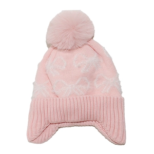 Detail showing pink knit hat with ear flaps, pom-pom, and white plush bow pattern