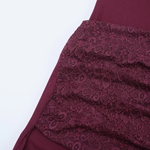 Close-up of burgundy floral lace texture and stitching details on a deep V-neck dress