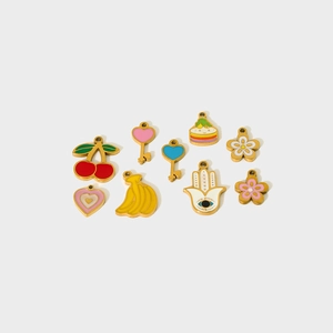 Flat lay of colorful enamel alloy charms featuring cherry, heart, and flower designs