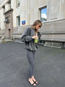 Detail of vintage washed charcoal grey sweatshirt paired with matching tight yoga pants