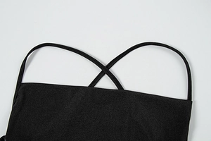 Close-up of elegant black satin dress featuring thin criss-cross adjustable back straps