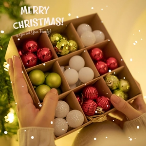Red green and white Christmas ball ornament set in a gift box with warm festive lighting