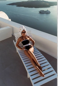 Detail view of black and white contrast swimwear with belt buckle on beach background