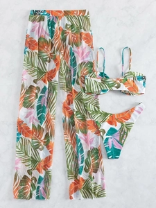 Flat lay of 3-piece tropical leaf print bikini set with matching wide-leg mesh trousers