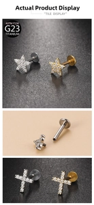 Detailed view of G23 titanium labret studs with star and cross zircon settings
