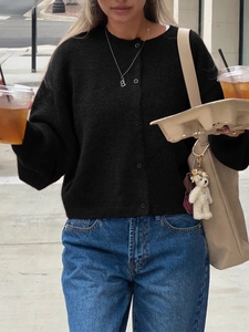 Classic black knitted long-sleeve cardigan with buttons for women in casual outdoor street style