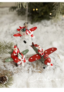 Three iron Christmas pendants with Santa on a plane set in a snowy forest scene