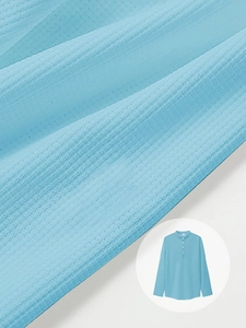 Macro shot of light blue polo shirt fabric showing breathable knit texture and henley collar
