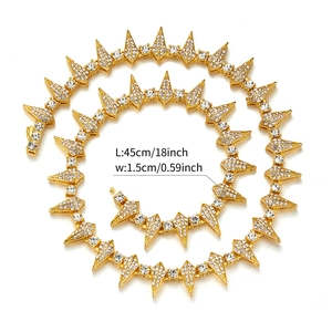 Detail of 18 inch gold hip hop Cuban chain with spiked links and clear rhinestones