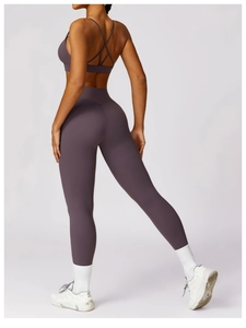 Rear view of purple high-waisted yoga leggings and cross-back sports bra set