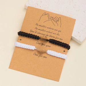 Handmade woven spider and web charm bracelets for couples on a decorative card