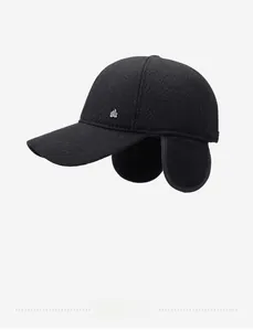 Detail view of winter baseball cap showing textured black fabric and ear protection