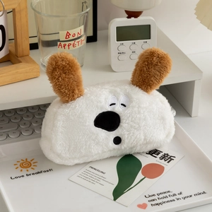 Detail of cute plush dog pencil case featuring soft white fabric and brown floppy ears