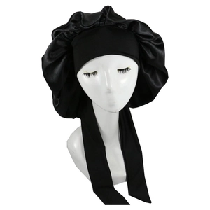 Detail view of black satin bonnet with wide elastic band and long ties on a model head
