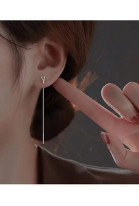 Detail of silver long tassel pull-through earring featuring a minimalist letter Y design
