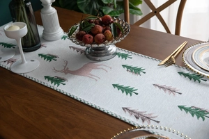 Close-up of jacquard table runner with Christmas reindeer and pine tree festive patterns