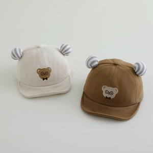 Detail of baby baseball caps in beige and brown with bear embroidery and soft ears