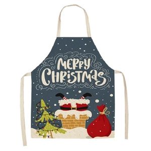 Detail of Christmas apron featuring white snowflakes and Merry Christmas text on navy linen