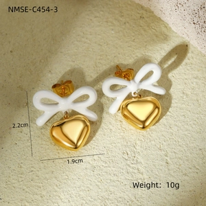 Macro shot of 18K gold-plated heart earrings with white bow detail and 2.2cm dimensions