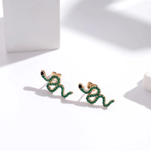 Chic gold-plated snake stud earrings with green micro-pave crystals on white stand