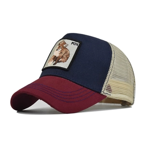 Close-up of animal fox embroidery patch on navy blue and burgundy mesh trucker hat