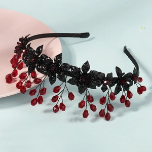 Detail of gothic floral headband with black flowers and hanging red crystal beads