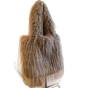 Large capacity light brown plush tote bag with long faux fur texture on display