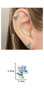 Macro detail of moon zircon stud earring with pink heart and screw back piercing design