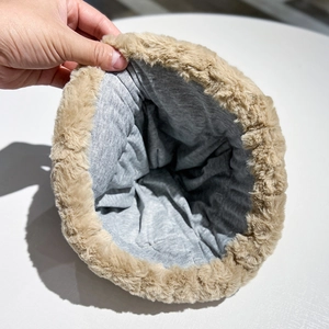 Close-up of winter hat interior featuring grey cotton lining and khaki faux fur trim
