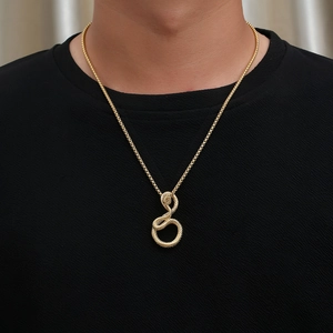Detail of vintage snake pendant necklace in gold finish worn by male model on black t-shirt