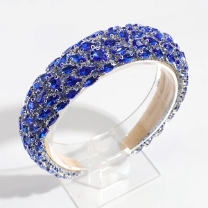 Close-up of baroque headband featuring blue pear-shaped crystals and silver beads