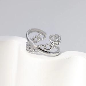 Detailed close-up of a dual-band stainless steel ring with curb chain and polished texture