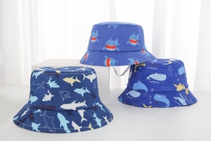 Detailed close-up of blue cotton sun hats for toddlers featuring ocean shark patterns