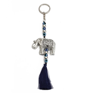 Silver elephant evil eye keychain featuring blue fringe tassel and beads on white background