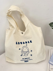 Cream canvas tote bag with cute cartoon rabbit astronaut print and wide shoulder strap