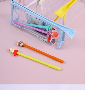 Detail view of transparent PVC pencil case with colorful zippers and stationery inside
