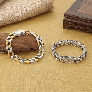 Detailed macro view of vintage engraved stainless steel Cuban bracelets in gold and silver