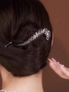 Macro shot of an elegant rhinestone hair clip styled in a woman's updo hairstyle