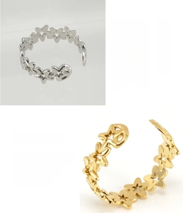 Detail of 18K gold plated and silver stainless steel open rings with star cutouts