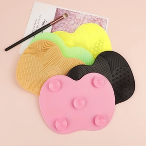 Detailed view of 5-piece silicone brush cleaning pads with textures and suction cups