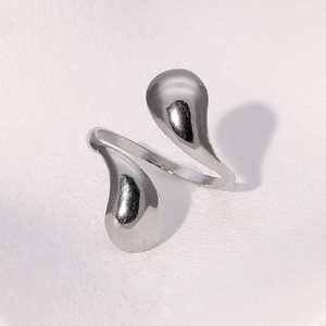 Macro shot of silver teardrop open ring with high-polish mirror finish on white background