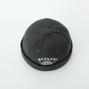 Detail view of cotton docker hat with white Weekend 1983 embroidery and metal eyelets